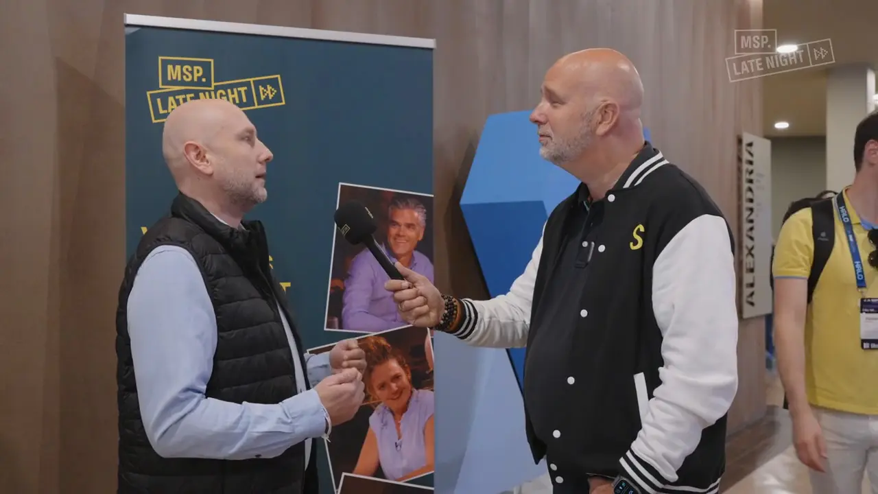 MSP on Tour: the host holds the mic for his guest at MSP Global 2026